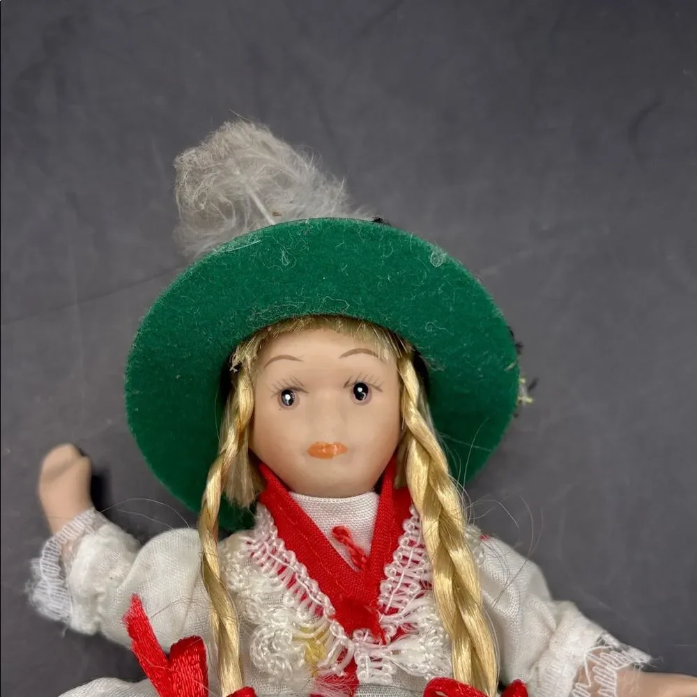 Traditional vintage porcelain doll with Green Hat and Dress